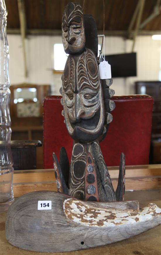 A Sepik river mask and a similar finial